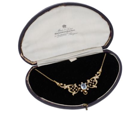 An aquamarine and seed pearl necklace, circa 1900, the cable-link chain leading to a scrolling frontispiece with trellis deta
