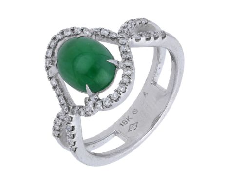 A jade and diamond ring, the jade cabochon claw-set within an entwined surround of brilliant-cut diamonds, to matching bifurc