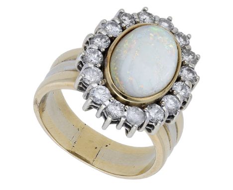 An opal and diamond cluster ring, the oval opal cabochon collet set within a brilliant-cut diamond cluster, to broad bicolour