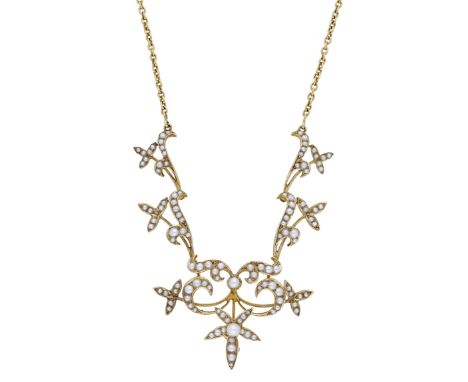 A seed pearl necklace, circa 1900, the articulated foliate necklace with a whiplash scroll and floral frontispiece, set throu