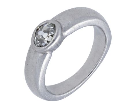 A diamond single stone ring, the old oval-shaped diamond in a rubover setting to a plain band, diamond weight approximately 0