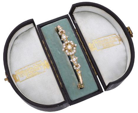A gold and pearl bangle, circa 1900, the hinged bangle set to the front with openwork seed pearl set detail, cased by Wathers