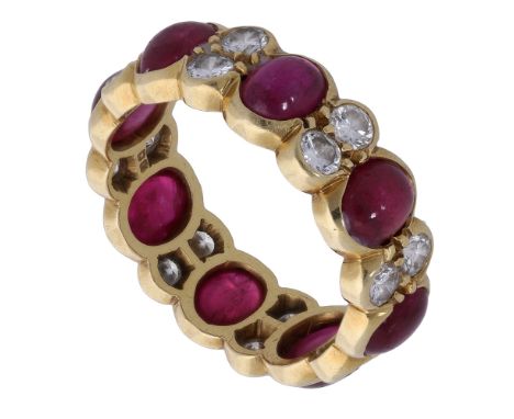 An 18ct gold ruby and diamond eternity ring, the cabochon rubies spaced by duos of brilliant-cut diamonds, London hallmark fo