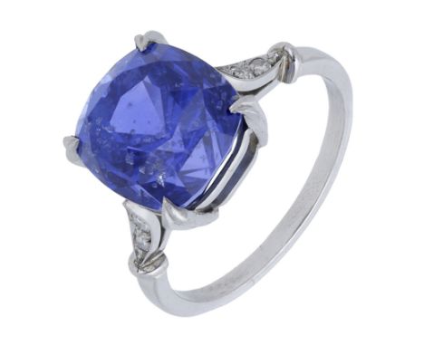 A colour change sapphire ring, the cushion-shaped sapphire weighing 9.15 carats, and claw-set to single-cut diamond shoulders