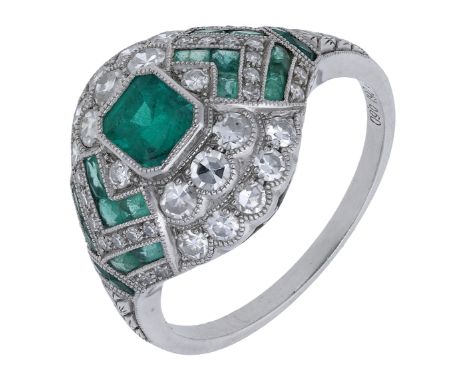 An emerald and diamond dress ring, of bombé design, set with a step-cut emerald within a surround of single-cut diamonds and 