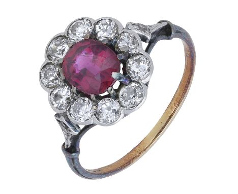 An early 20th century ruby and diamond cluster ring, the oval-cut ruby within a surround of old brilliant-cut diamonds, to a 