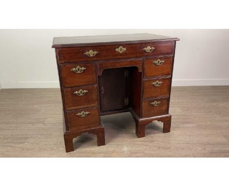 GEORGE III KNEEHOLE DESK,cross-banded mahogany, with arrangement of seven drawers and recessed cupboard door, on tall bracket