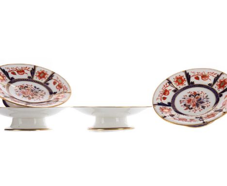 LATE VICTORIAN DESSERT SERVICE,comprising eighteen plates and four comports, decorated in the Imari palette, printed marks to