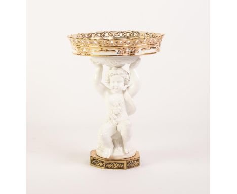 LATE NINETEENTH CENTURY WHITE GLAZED FIGURAL CHINA COMPORT, modelled as a seated Bacchanalian cherub supporting a shallow, lo