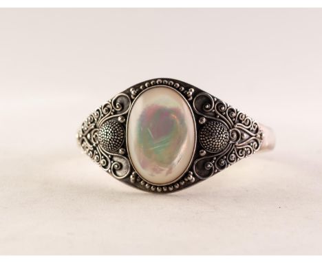 SUARTI SILVER TORQUE BANGLE, the broad top set with a large cabochon oval mother of pearl, with elaborate filigree decorated 