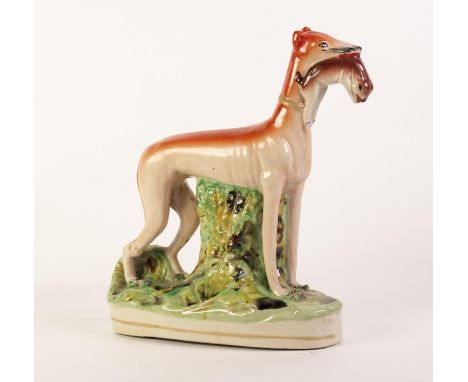 NINETEENTH CENTURY STAFFORDSHIRE POTTERY LARGE MODEL OF A GREYHOUND, painted in colours and typically modelled standing with 