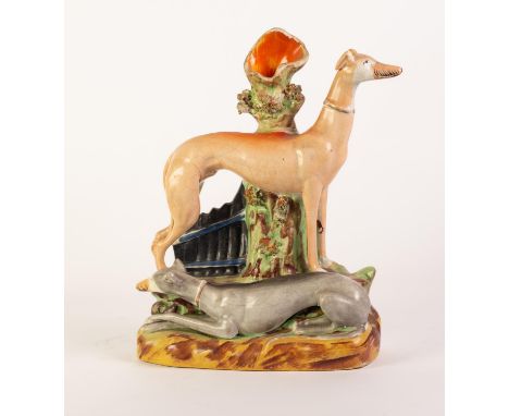 NINETEENTH CENTURY STAFFORDSHIRE POTTERY LARGE GREYHOUND SPILL GROUP, painted in colours and modelled with a standing light b