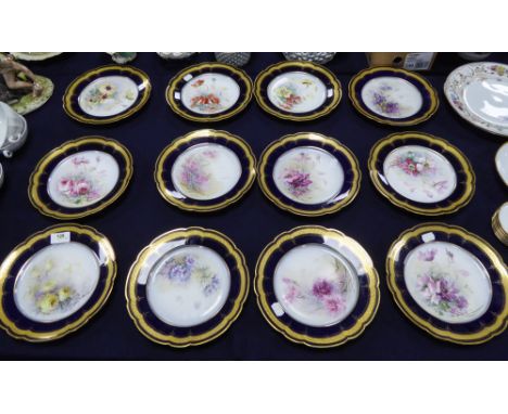 SET OF TWELVE W.G &amp; Co LIMOGES PORCELAIN DESSERT PLATES, SIGNED GOUMONDIE each with hand painted floral centre within a b