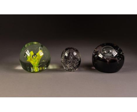 THREE GLASS PAPERWEIGHTS, comprising: CAITHNESS ?NIGHT VENTURE?. MILLRACE, HOLMFIRTH and an EARLIER EXAMPLE WITH YELLOW FLOWE