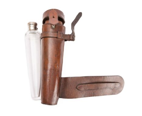 A mid 20th century silver plated and tapering glass hunting flask unmarked, 23.5cm long, in a leather saddle case