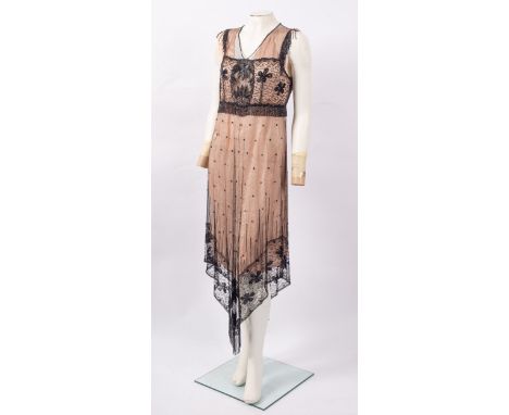 An Art Deco 'flapper' black beaded dress, approximately 142cm overall, with a peach coloured underdress; together with a silv