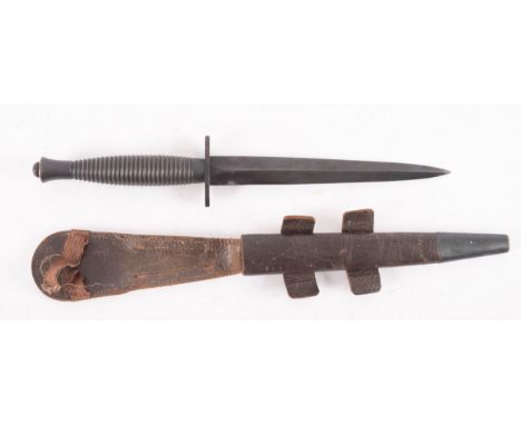 A Fairbairn Sykes fighting knife, third pattern. the straight double edged blade, over an oval hilt stamped AB2, a one piece 