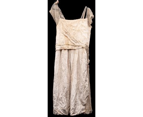 An Edwardian/Art Deco white lace and velvet  sleeveless wedding dress, the lace shoulder  embellished with a flower to one si