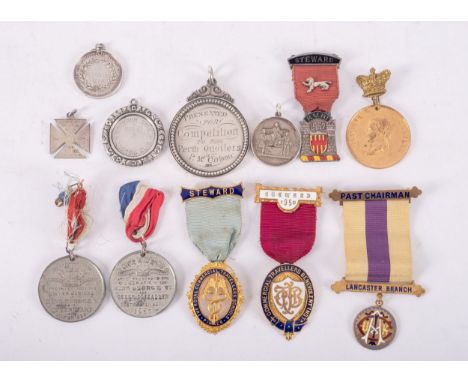 A group of various silver, gilt and enamel association badges and awards, including  five silver award medallions, various ma