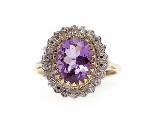 NINE CARAT GOLD AMETHYST AND DIAMOND RINGset with an oval amethyst 9.8mm long, within an illusion set diamond halo, the diamo
