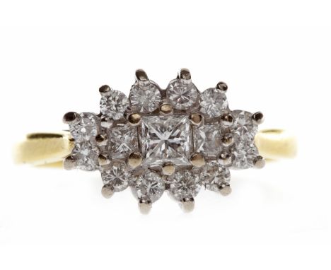 EIGHTEEN CARAT GOLD DIAMOND CLUSTER RINGset with a central princess cut diamond of approximately 0.20 carats and flanked by t