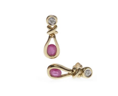 PAIR OF NINE CARAT GOLD RUBY DROP EARRINGSeach of open form and set with a single oval ruby within a pear shaped drop and sus