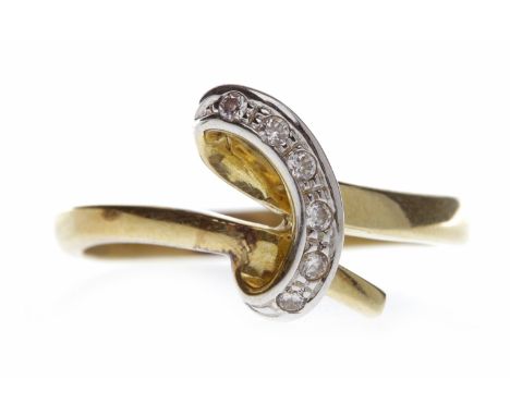 FOURTEEN CARAT GOLD GEM SET DRESS RINGwith an open raised twisted bezel set with round white gems, size R, 3.6g
