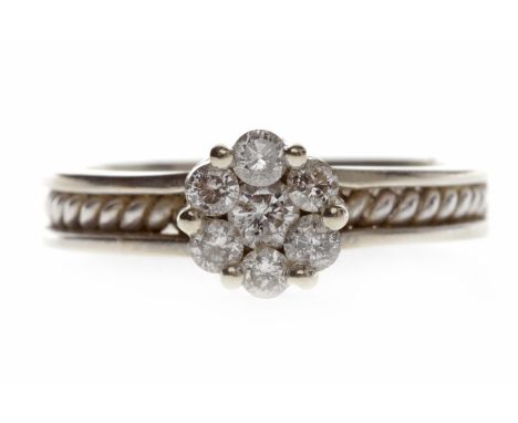 FOURTEEN CARAT WHITE GOLD DIAMOND CLUSTER RINGthe diamond daisy bezel set with round brilliant cut diamonds totalling approxi