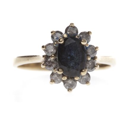 FOURTEEN CARAT GOLD GEM SET RINGset with a central oval blue gem 7.1mm long surrounded by round white pastes, size L-M, 2.8g