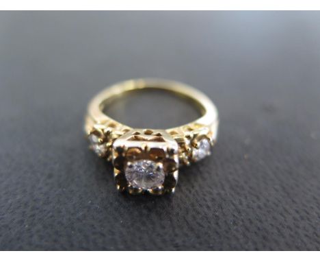 A 14ct yellow gold three stone diamond ring size L - weight approx 3.8 grams - some light scratches, usage marks, wear 