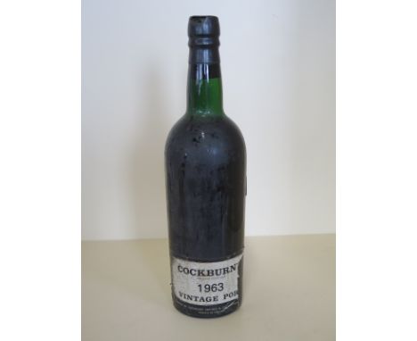 A bottle of 1963 Cockburn Vintage Port level to bare of neck 
