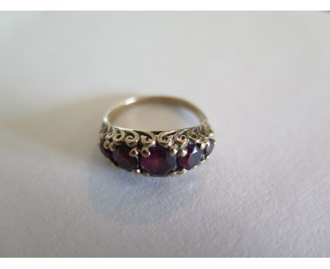 A Victorian style five stone garnet and 9ct gold ring set with five graduated stones, the central stone measures approx .75ct