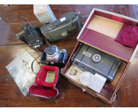 Two Polaroid land cameras, a Zeiss Ikon Contarex camera and a Polaroid square shooter 