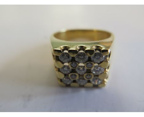 An 18ct yellow gold ladies or gents diamond ring set with thirteen stones, nine of approx nine points and four of approx thre