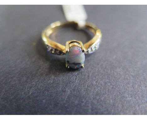 A 9ct yellow gold opal and diamond ring - Size N - approx 2.3 grams - in good condition 