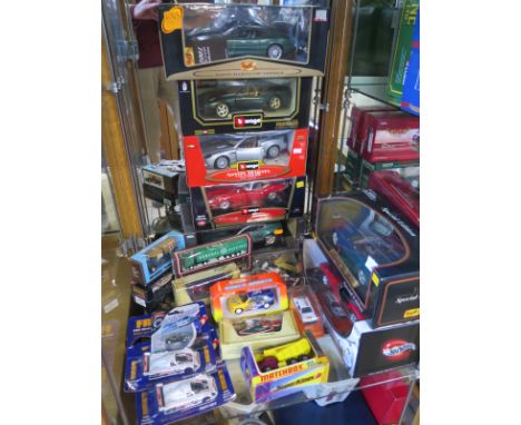 Seven x 1-18 scale diecast cars and thirteen other diecast vehicles all boxed - in good condition 