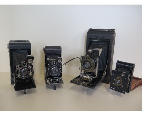 Four folding cameras, three are Kodak including a vest pocket camera with a Zeiss Tessar lens, a Deco Kodak and an oversized 