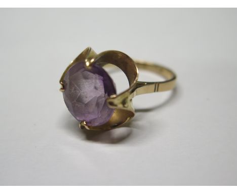 A large foreign gold amethyst ring stamped 18K set with a round cut amethyst - diameter approx 13mm - ring size N 1/2 - weigh