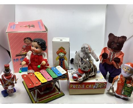 A good Selection of Vintage wind up clockwork toys to include a child doll at a xylophone, an elephant with cymbals, a clockw