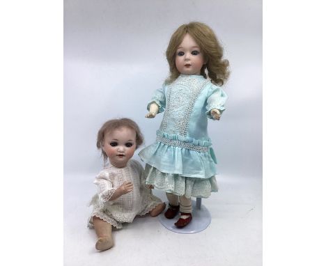 Antique German bisque head dolls ; a Gebruder Heubach 8192 15” bisque head , original body doll with replaced wig, original p