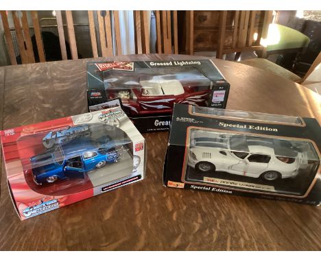 3 larger scale model cars to include a grease movie vehicle and a Dodge Viper car and and another-all neat boxed scale toys d