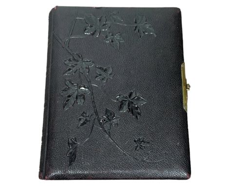 A 19th century leather bound photo album in a textured leather embossed with trailing  ivy leaves. The pages are gilt edges a