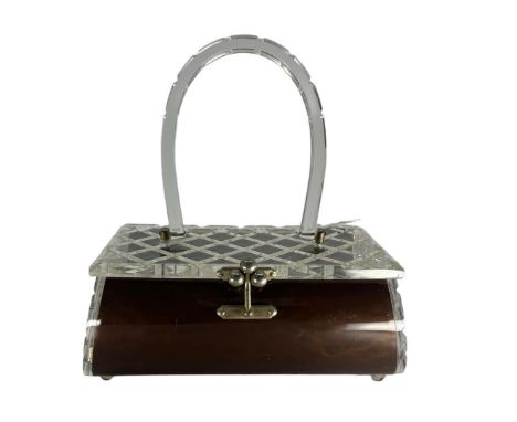 A c1950s Lucite bag by Charles S Khan of Miami. The front, back and base are formed from a curved brown pearlised Lucite and 