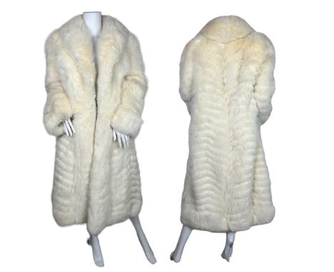 A vintage arctic fox coat with an ivory satin lining. There is an internal swing tie and fur clips to fasten(1) Lining has so