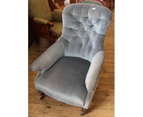 A Victorian button back blue velour upholstered armchair