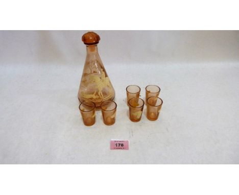 A small decanter with six shot glasses decorated with hunt scenes