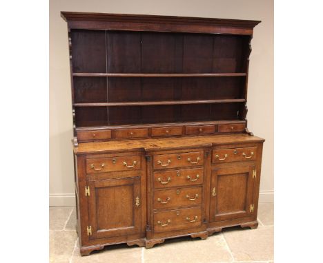 A George III oak Welsh dresser, probably Conwy Valley, the enclosed plate rack with a moulded cornice and plain frieze over a