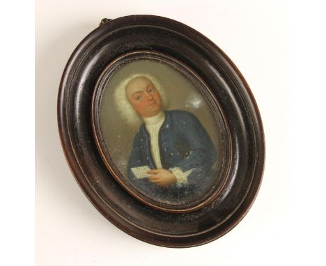English School (18th century),A portrait miniature depicting a gentleman in a blue frock coat holding a letter,Watercolour,Un