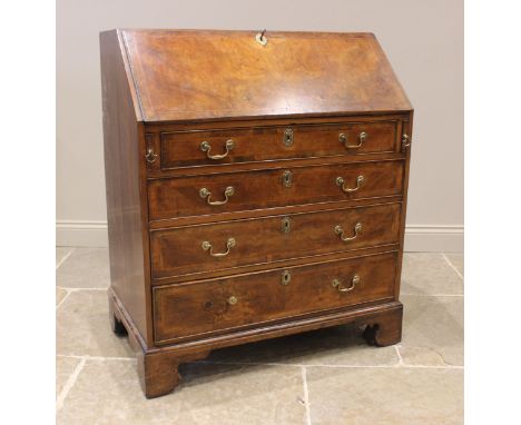 A George III walnut bureau, the book veneered and feather banded fall front opening to a compartmented interior above four gr