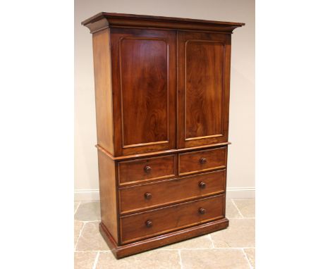 A Victorian mahogany linen press, the cavetto cornice over a pair of arch moulded cupboard doors opening to three sliding tra